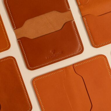 Stylish brown leather wallets with unique stitching, perfect for luxury and fashion lovers.